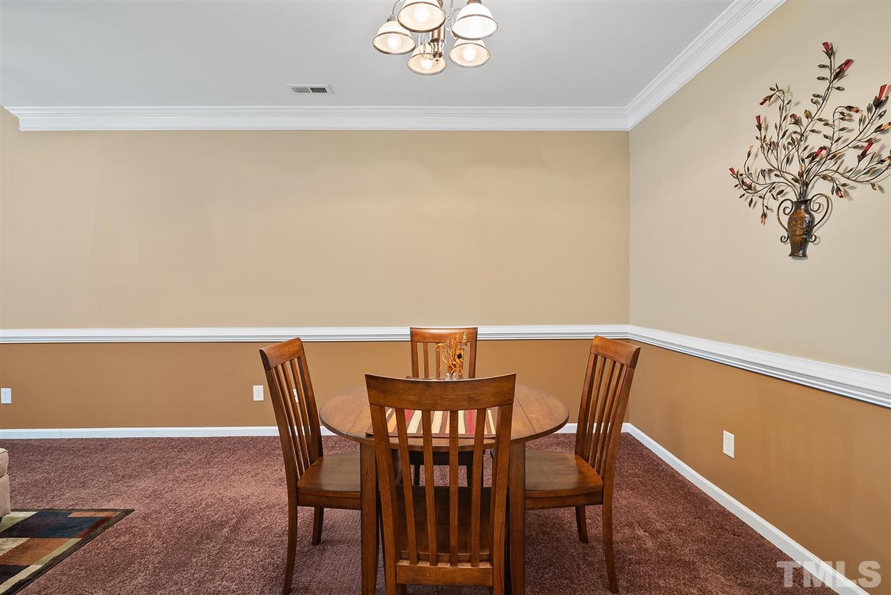 2632 Andover Glen Road Raleigh, NC 27604 - Photo 12 of 23 a view of a dining room with furniture and wooden floor