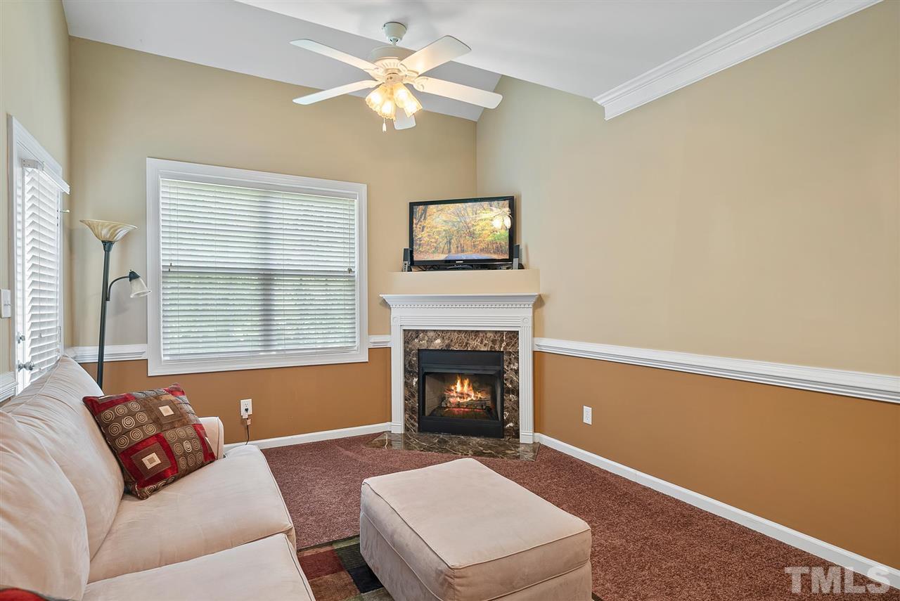 2632 Andover Glen Road Raleigh, NC 27604 - Photo 15 of 23 a living room with furniture and a fireplace