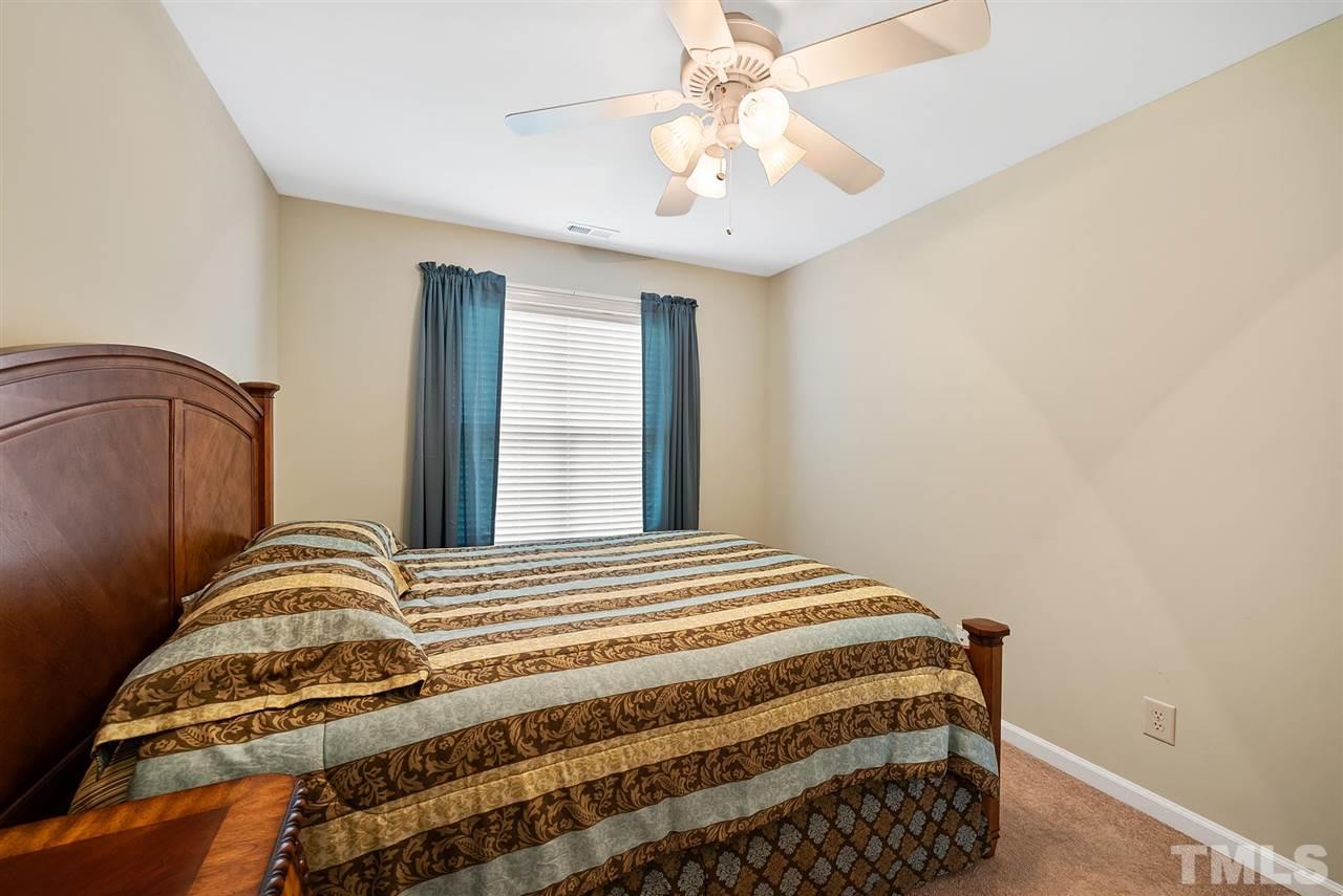 2632 Andover Glen Road Raleigh, NC 27604 - Photo 22 of 23 a bedroom with a bed and a chandelier