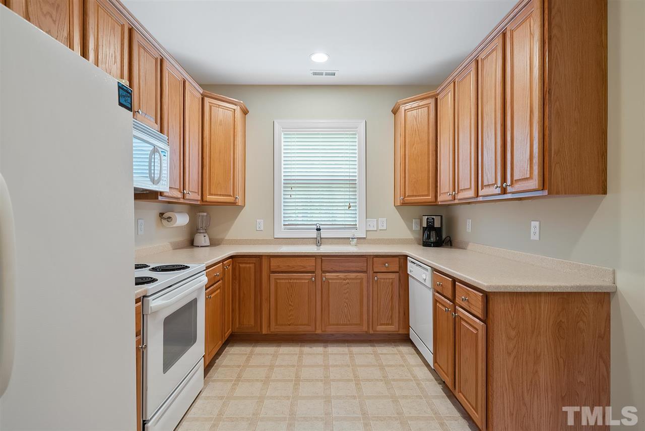 2632 Andover Glen Road Raleigh, NC 27604 - Photo 9 of 23 a kitchen with stainless steel appliances granite countertop a sink stove and cabinets