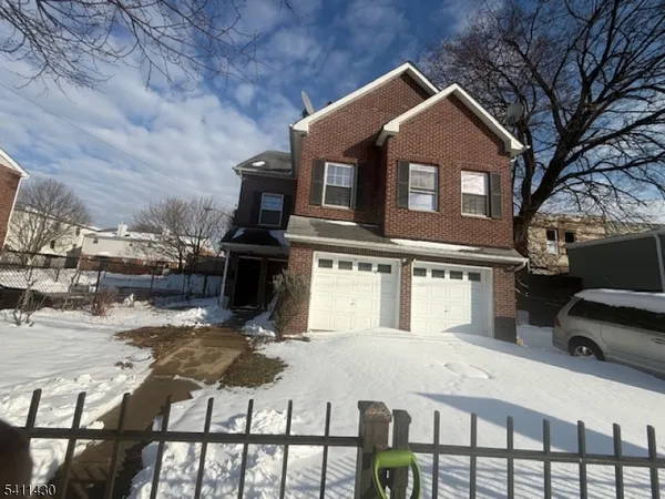 a front view of a house with parking area