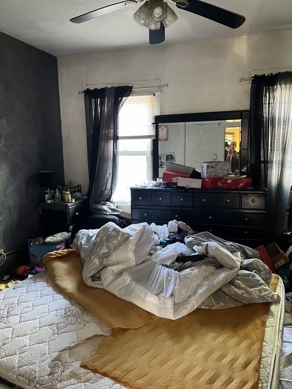 119 Rodney Street Worcester, MA 01605 - Photo 15 of 21 a bed sitting in a room next to a window