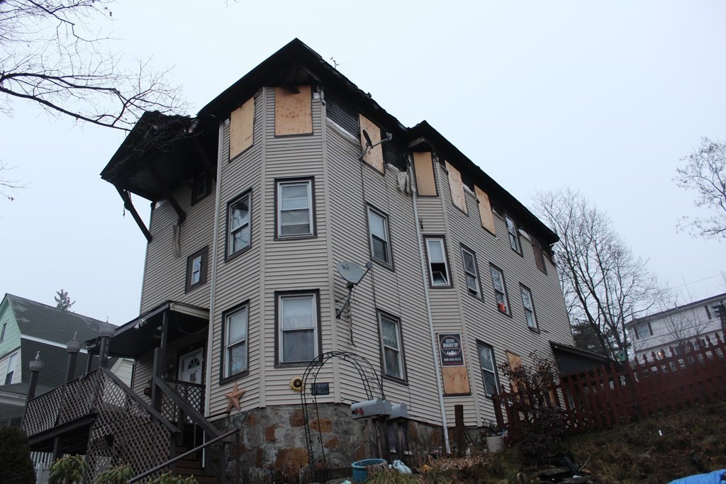 119 Rodney Street Worcester, MA 01605 - Photo 3 of 21 a front view of a house with a yard
