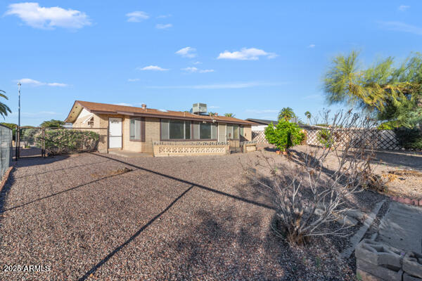 6117 East Decatur Street Mesa, AZ 85205 - Photo 21 of 29 a view of a house with a yard and potted plants
