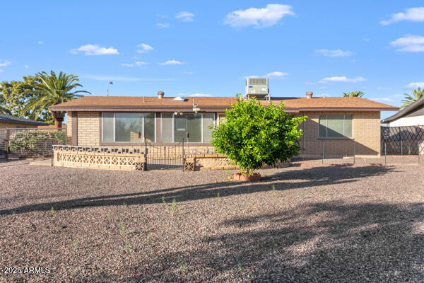 6117 East Decatur Street Mesa, AZ 85205 - Photo 22 of 29 a front view of a house with a yard and potted plants