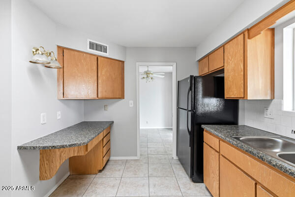 6117 East Decatur Street Mesa, AZ 85205 - Photo 8 of 29 a kitchen with stainless steel appliances granite countertop a refrigerator and a sink