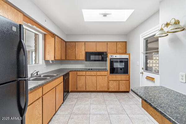 6117 East Decatur Street Mesa, AZ 85205 - Photo 9 of 29 a kitchen with stainless steel appliances granite countertop a refrigerator and stove