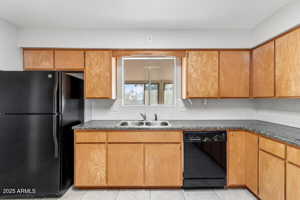 6117 East Decatur Street Mesa, AZ 85205 - Photo 10 of 29 a kitchen with a sink a refrigerator and cabinets