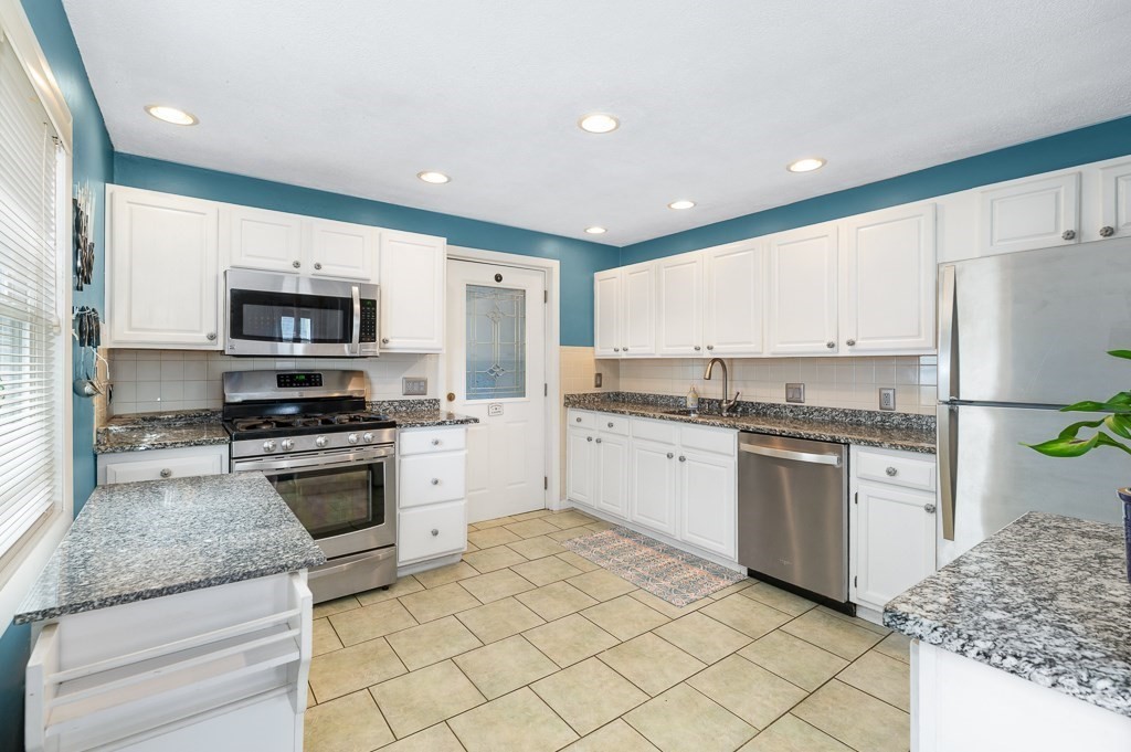 9 Alpine Court Gloucester, MA 01930 - Photo 13 of 32 a kitchen with granite countertop a refrigerator stove top oven and sink
