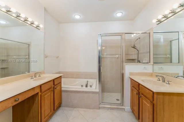 a bathroom with a double vanity sink mirror double and shower