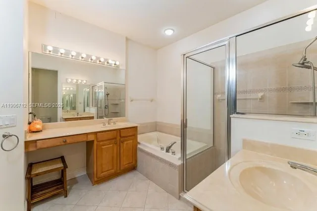 a bathroom with a tub sink shower and mirror
