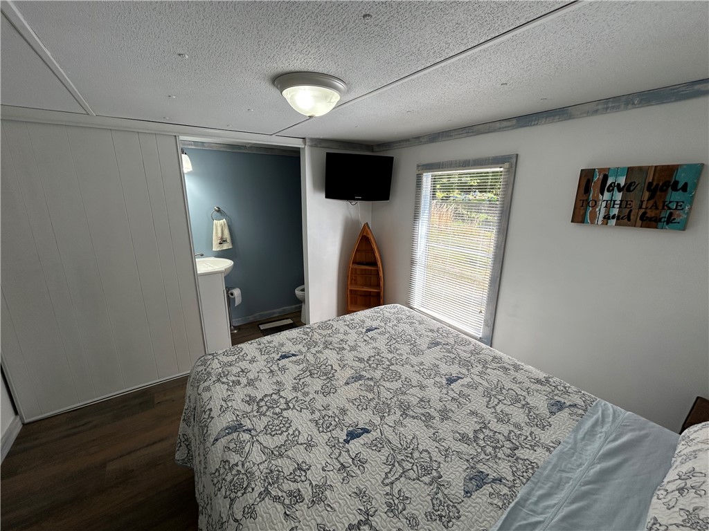 43 Sunset Cove Road Abbeville, SC 29620 - Photo 18 of 41 This cozy bedroom features durable flooring and convenient access to a private bath.