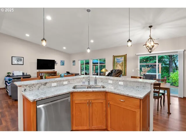 a kitchen with kitchen island a counter space a sink and appliances