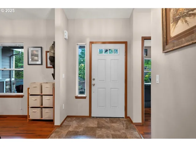 hallway view with wooden floor and windows