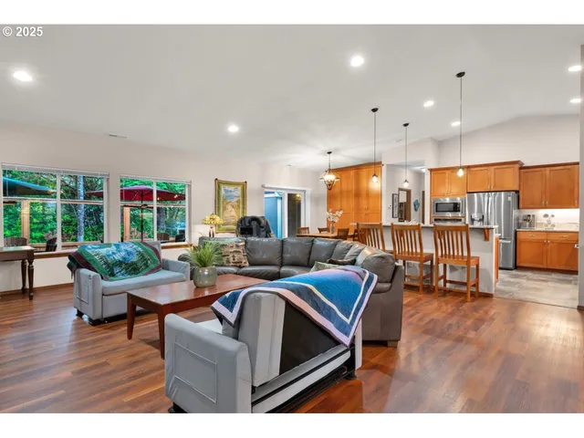 a living room with lots of furniture and kitchen view