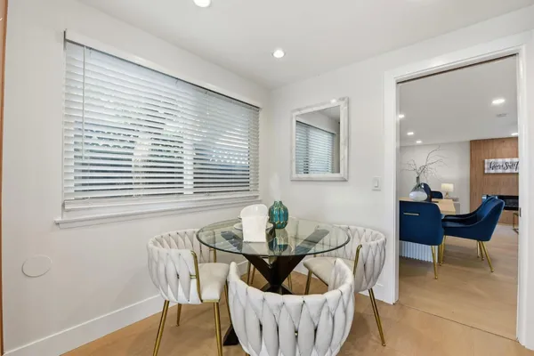 a view of a dining room with furniture and wooden floor