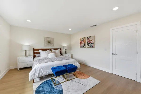 a spacious bedroom with a bed and a couch
