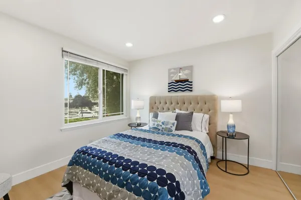 a bedroom with a bed and a window