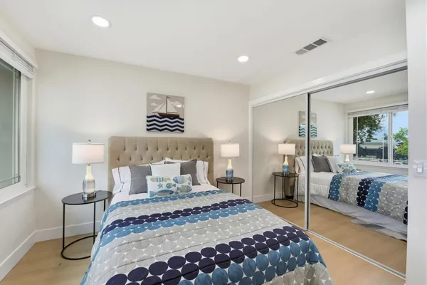 a bedroom with a large bed and a chandelier