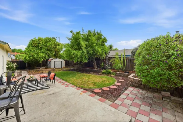 a view of a swimming pool with a patio and a yard
