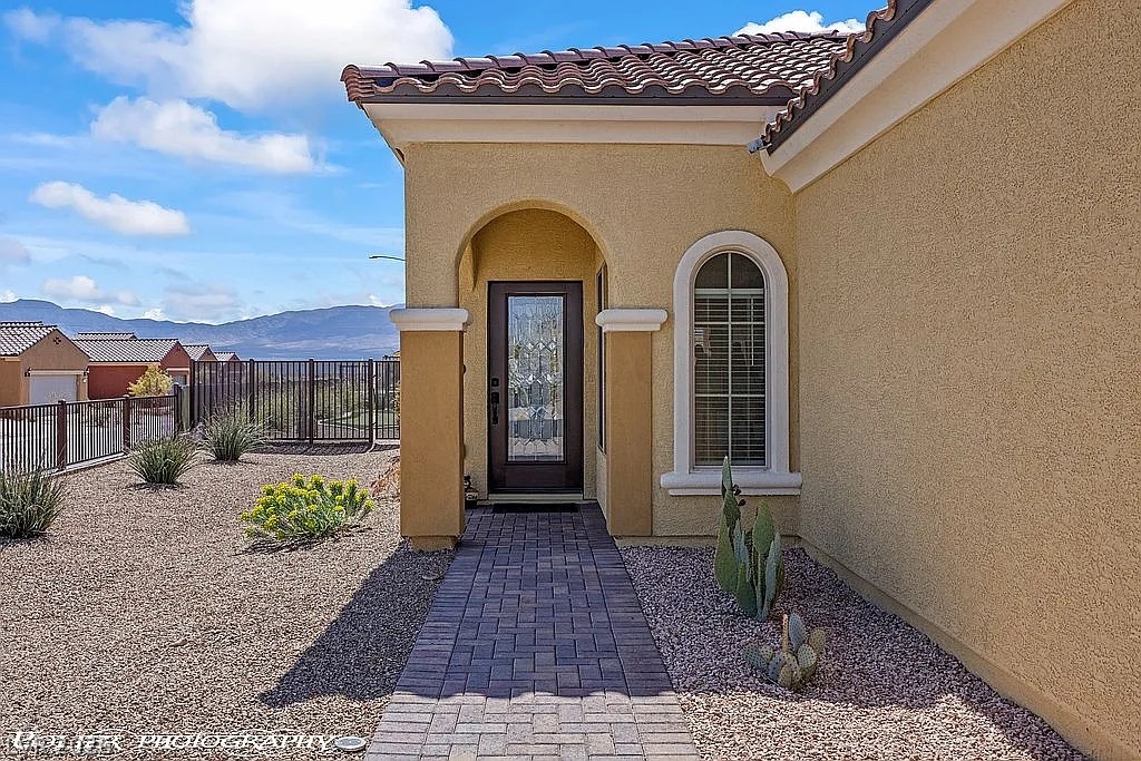 1304 Cottage Ridge Mesquite, NV 89034 - Photo 41 of 52 A welcoming arched entryway introduces this desert-friendly stucco home with a tile roof.