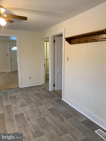 a view of a house with a backyard and a car parked