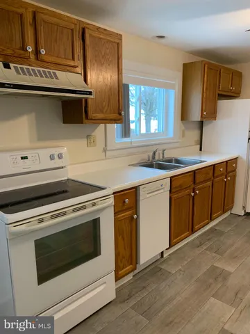 a spacious bathroom with a granite countertop sink a mirror and a shower