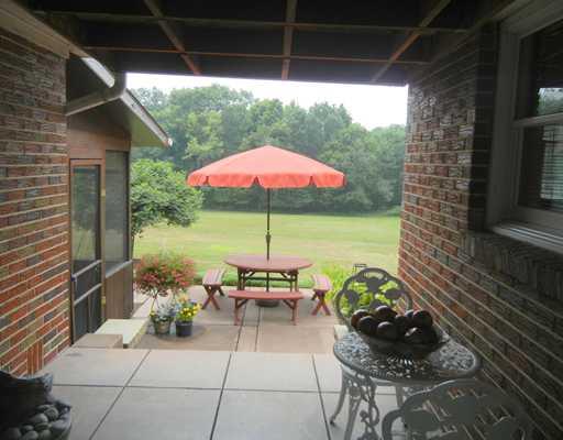 155 Country Lane Road Butler, PA 16001 - Photo 11 of 16 Patio/Deck. This ceramic tiled porch leads out to a patio and enclosed sunroom area overlooking a treed lot of 2+ acres