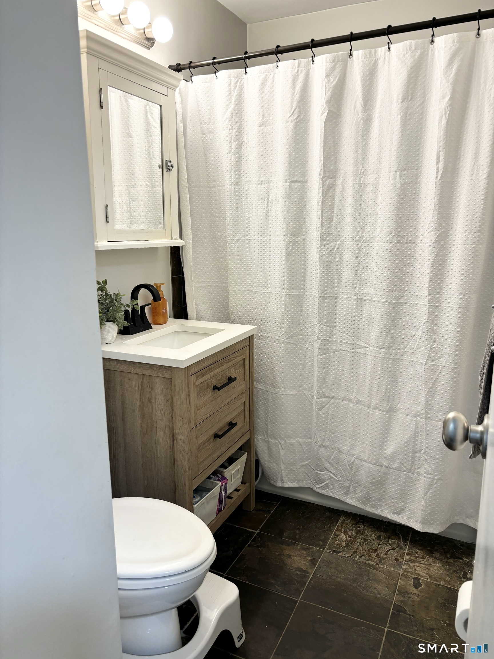 208 Flax Hill Road, Unit 12 Norwalk, CT 06854 - Photo 11 of 12 a bathroom with a sink a toilet and a window