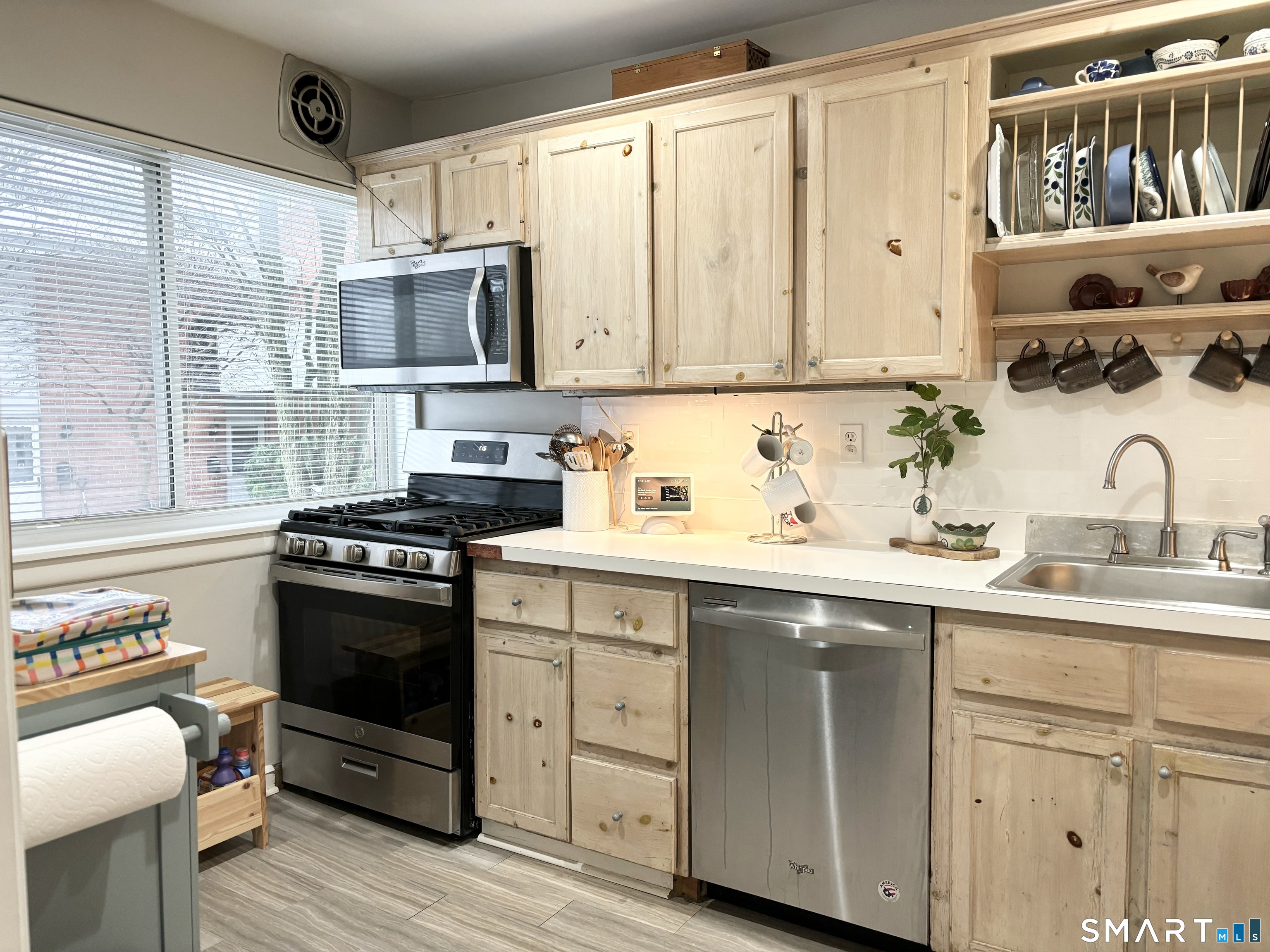 208 Flax Hill Road, Unit 12 Norwalk, CT 06854 - Photo 2 of 12 a kitchen with stainless steel appliances granite countertop a sink stove and cabinets