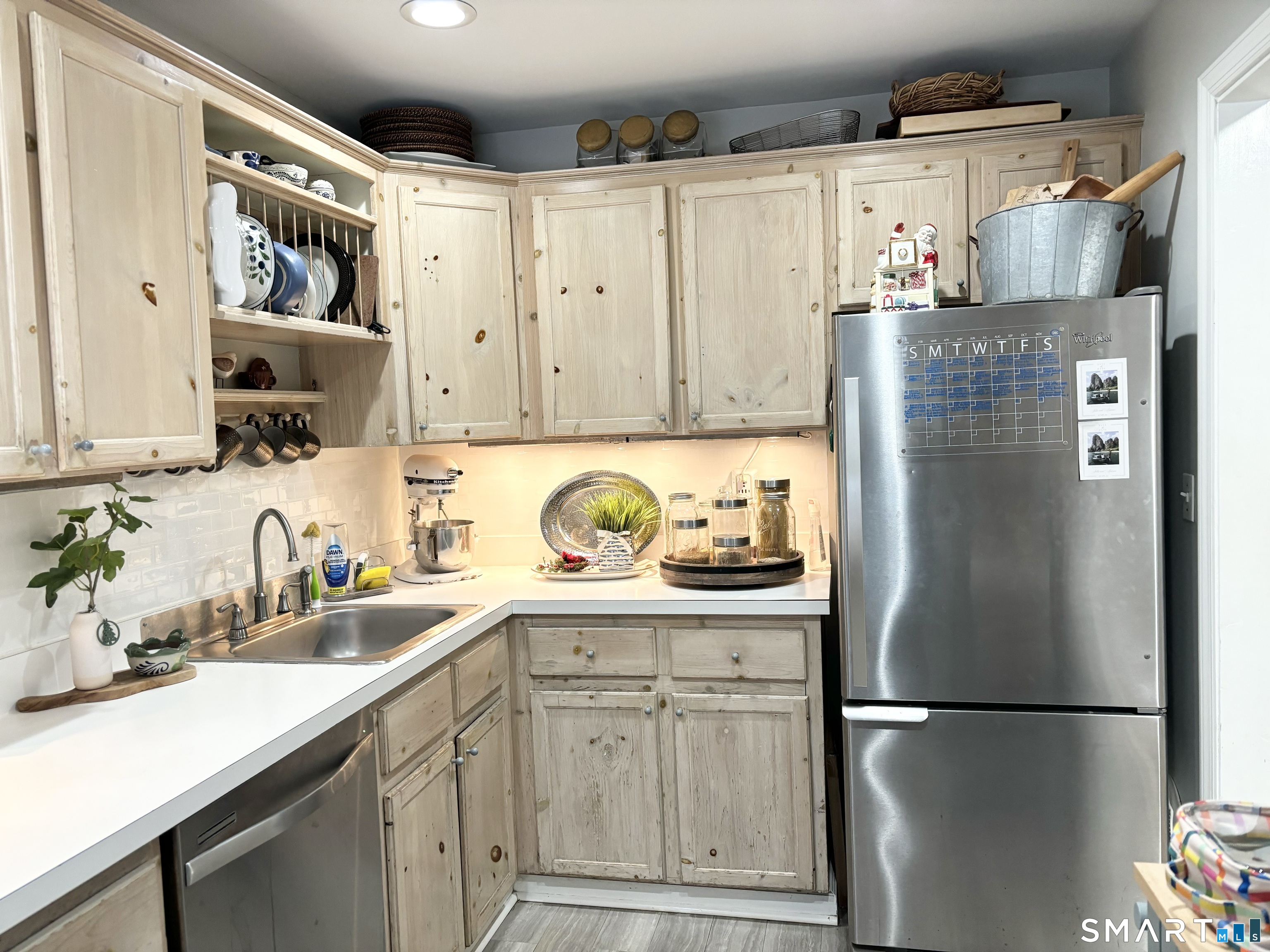 208 Flax Hill Road, Unit 12 Norwalk, CT 06854 - Photo 3 of 12 a kitchen with stainless steel appliances granite countertop a refrigerator and a sink