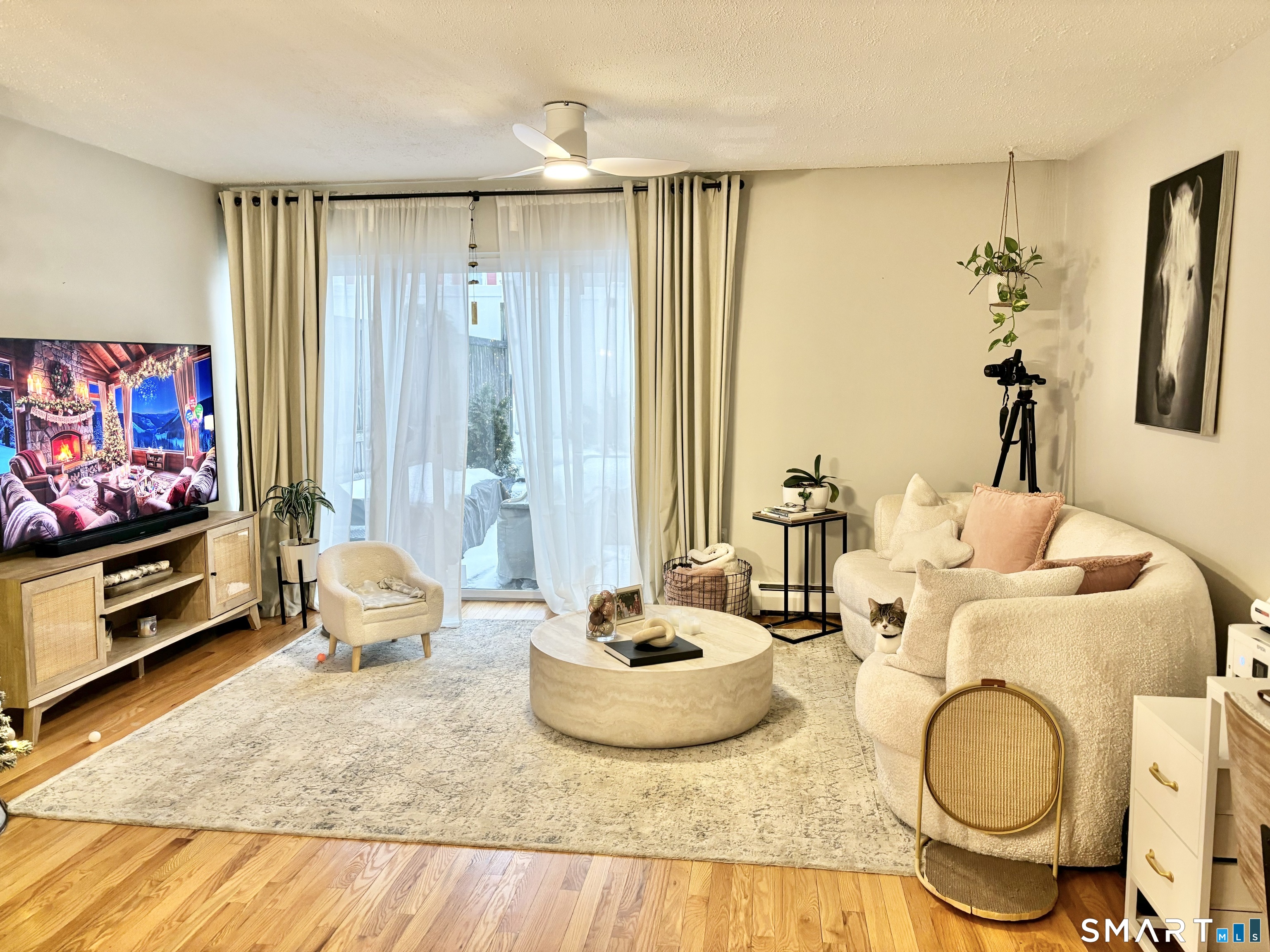 208 Flax Hill Road, Unit 12 Norwalk, CT 06854 - Photo 5 of 12 a living room with furniture and a flat screen tv