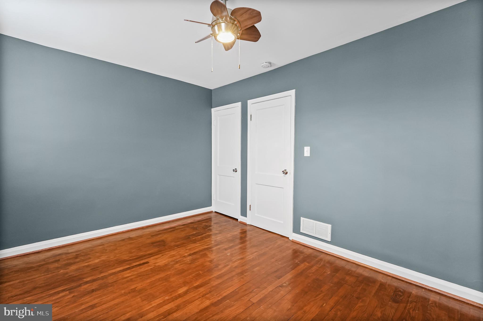 6920 Conley Street Baltimore, MD 21224 - Photo 8 of 12 a view of an empty room with wooden floor