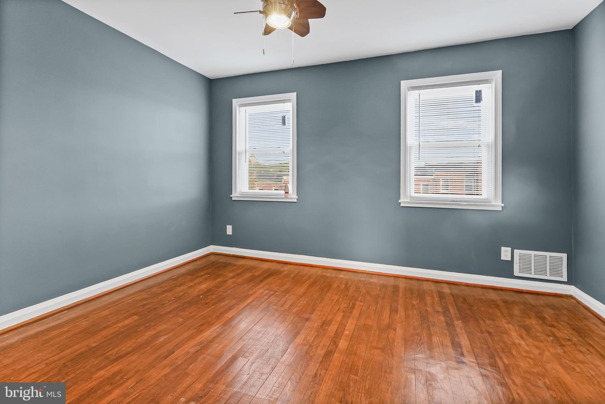6920 Conley Street Baltimore, MD 21224 - Photo 9 of 12 a view of an empty room with wooden floor and a window