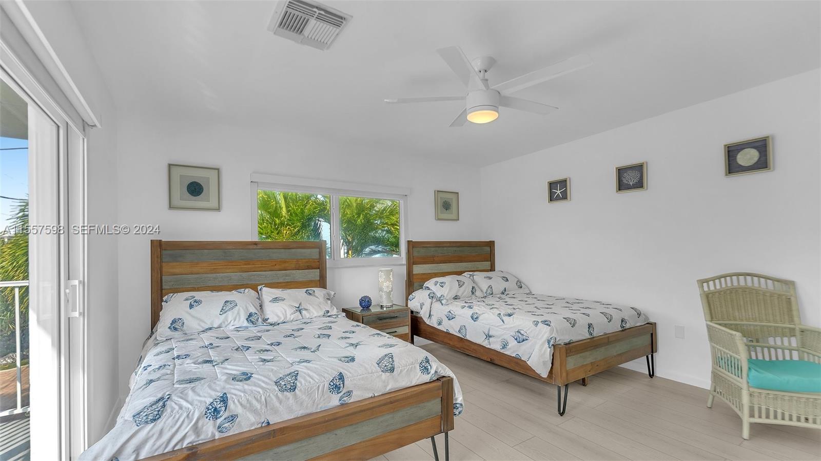 441 La Fitte Road Summerland Key, FL 33042 - Photo 24 of 81 a bedroom with two beds and painting on the wall