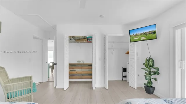 a living room with furniture a rug and white walls