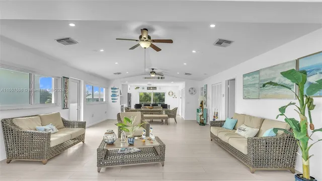 a living room with furniture a table and wooden floor