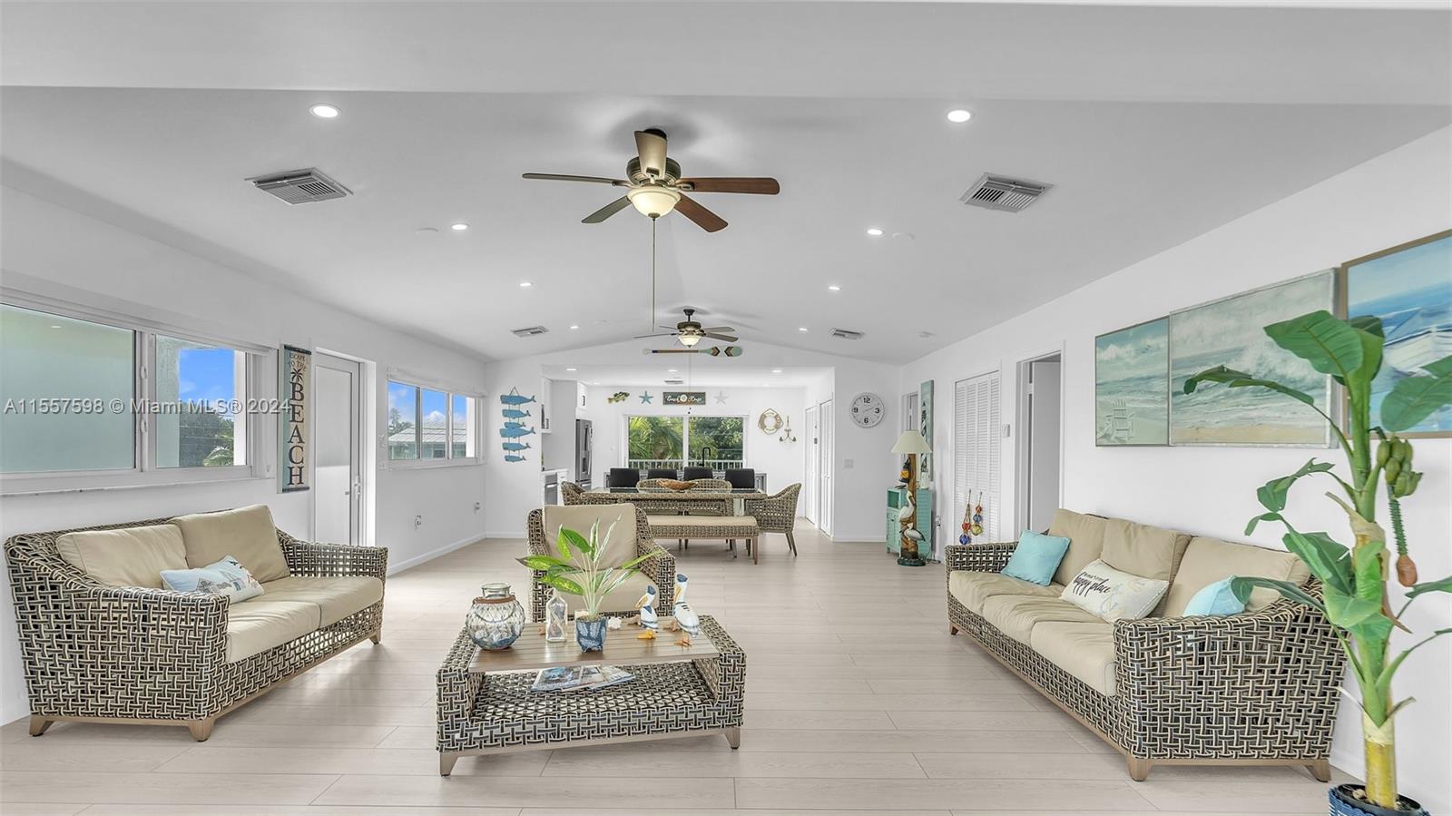 441 La Fitte Road Summerland Key, FL 33042 - Photo 27 of 81 a living room with furniture a chandelier and a dining table with wooden floor
