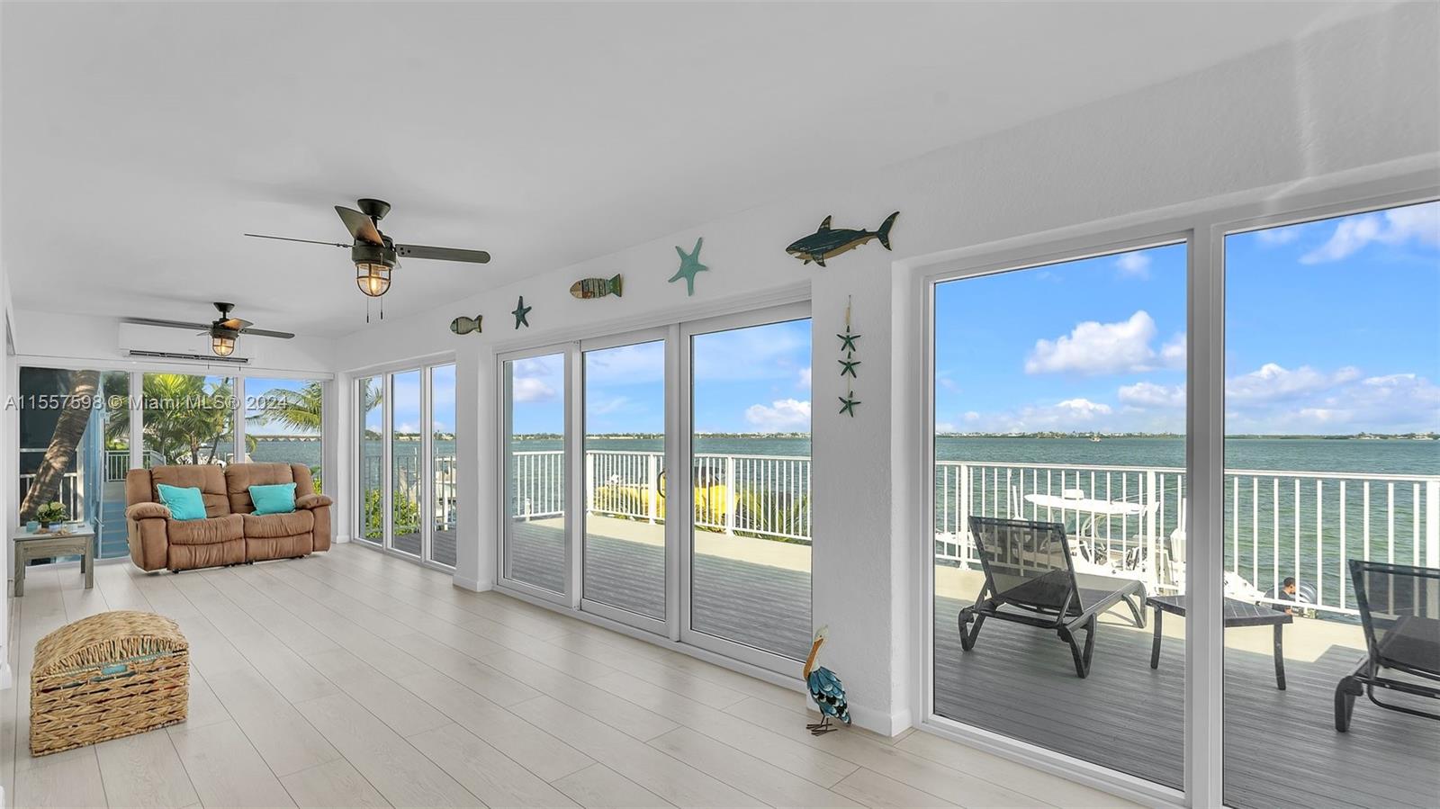 441 La Fitte Road Summerland Key, FL 33042 - Photo 29 of 81 a view of a livingroom with furniture wooden floor and a floor to ceiling window