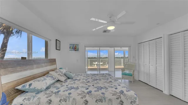 a kitchen with stainless steel appliances a sink a stove a refrigerator a dining table and chairs with wooden floor