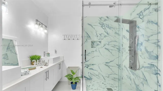 a kitchen with stainless steel appliances a refrigerator sink and microwave