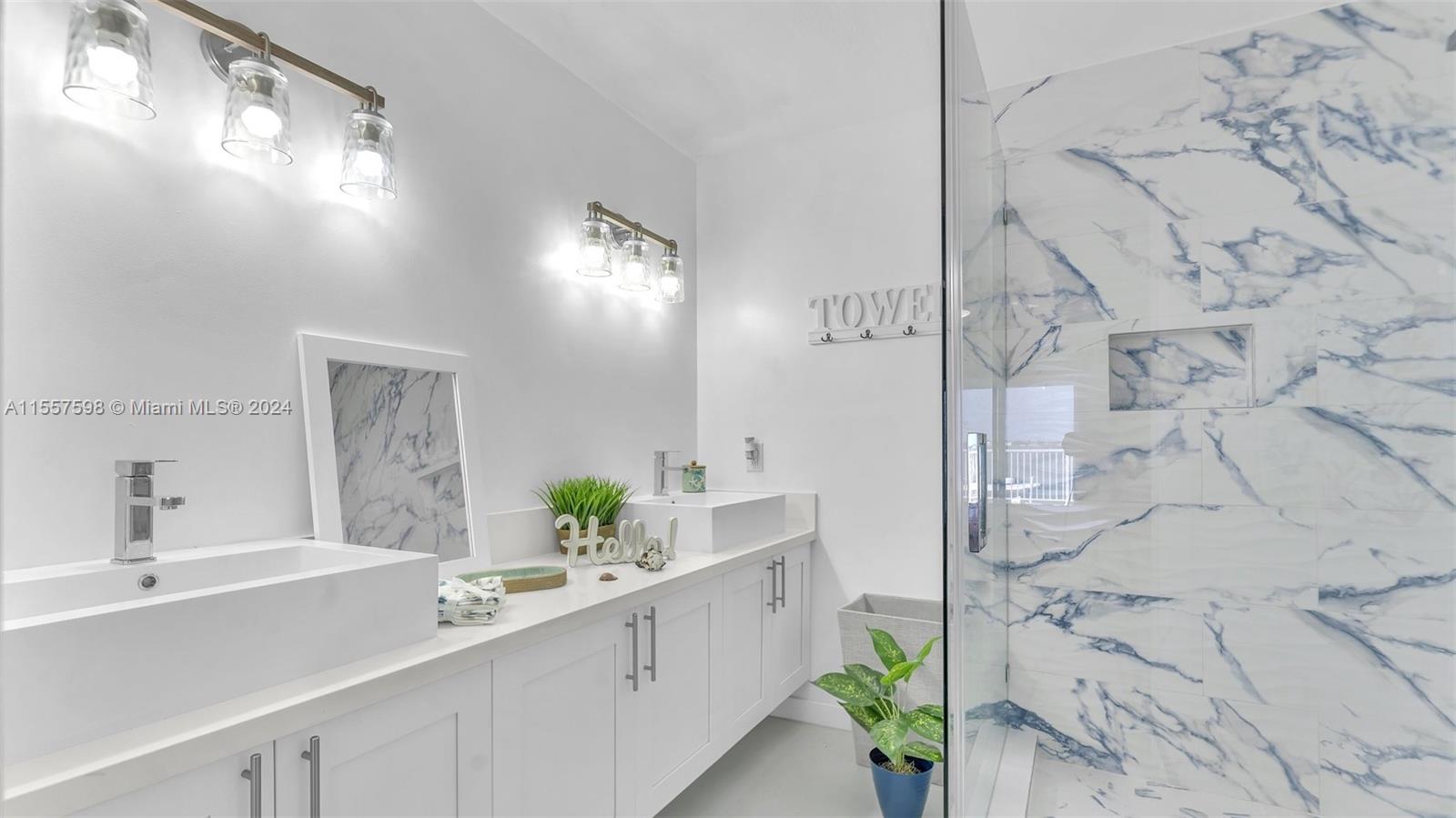 441 La Fitte Road Summerland Key, FL 33042 - Photo 37 of 81 a bathroom with a double vanity sink and a mirror