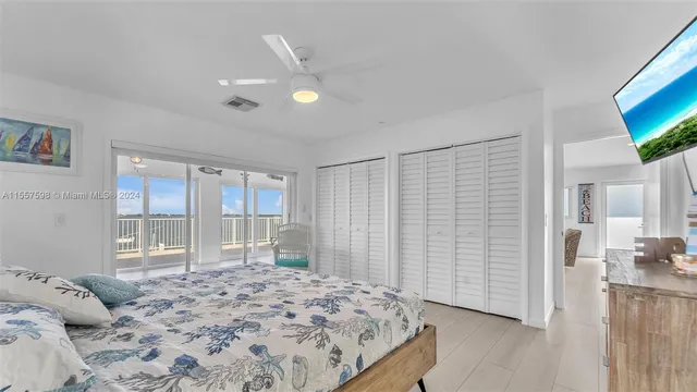 a kitchen with stainless steel appliances a sink a stove a refrigerator cabinets and living room view