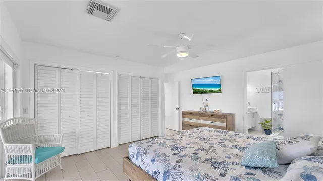 a bedroom with furniture and large window