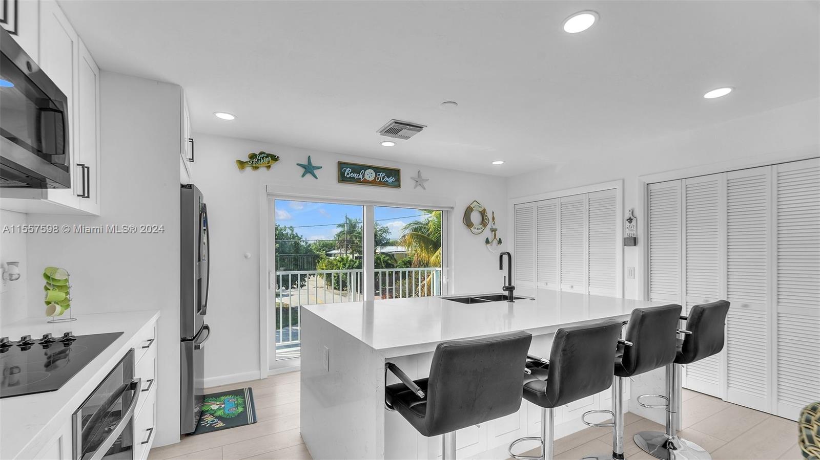 441 La Fitte Road Summerland Key, FL 33042 - Photo 52 of 81 a kitchen with stainless steel appliances kitchen island granite countertop a sink a stove and a refrigerator