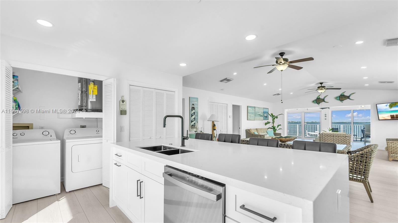 441 La Fitte Road Summerland Key, FL 33042 - Photo 56 of 81 a kitchen with stainless steel appliances a sink a stove a refrigerator cabinets and living room view