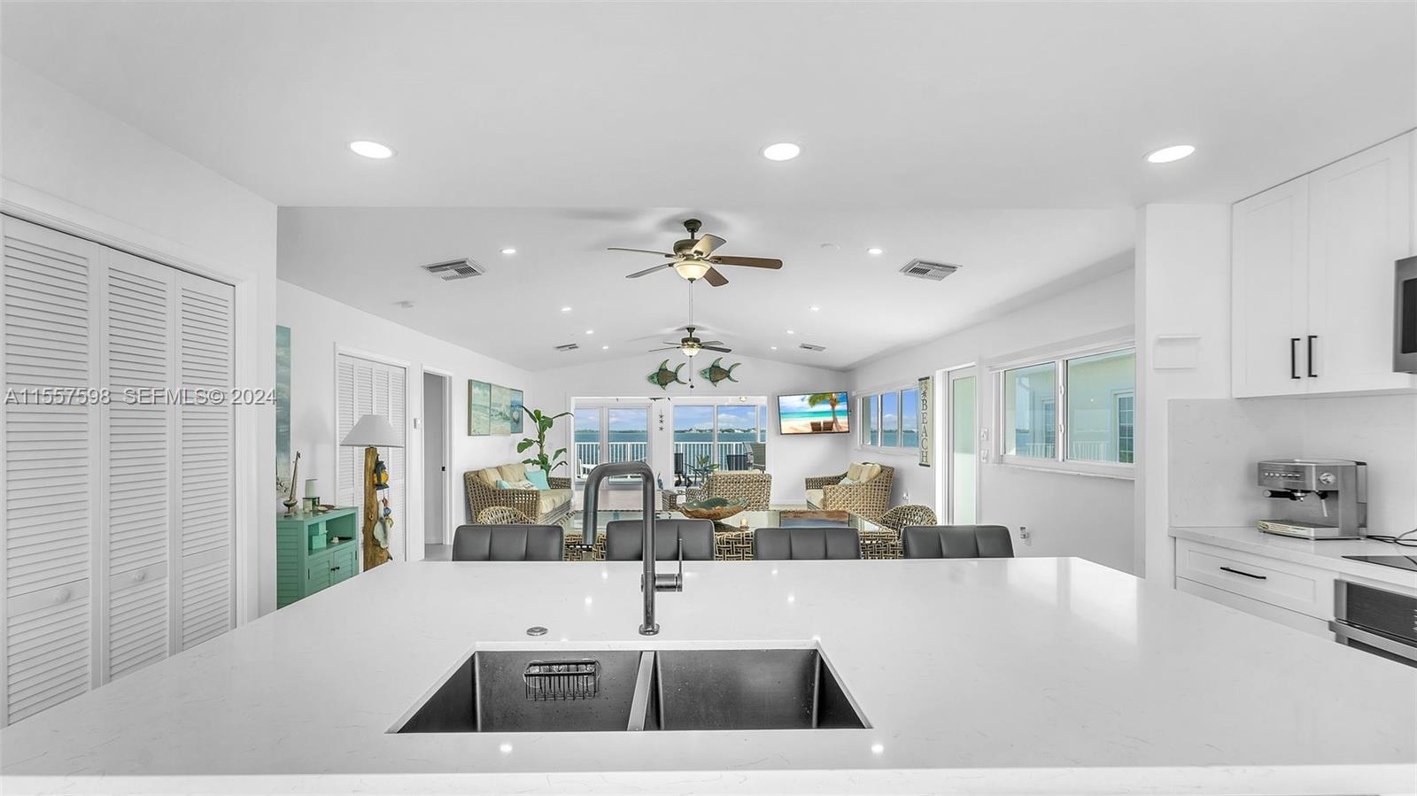 441 La Fitte Road Summerland Key, FL 33042 - Photo 57 of 81 a view of a kitchen with kitchen island a large window cabinets a sink and stainless steel appliances