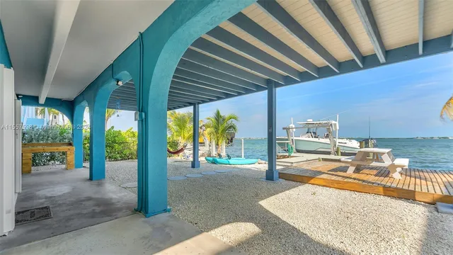 a view of a house with pool and sitting area