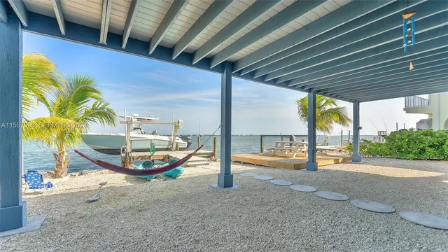 a bedroom with a bed and painting on the wall