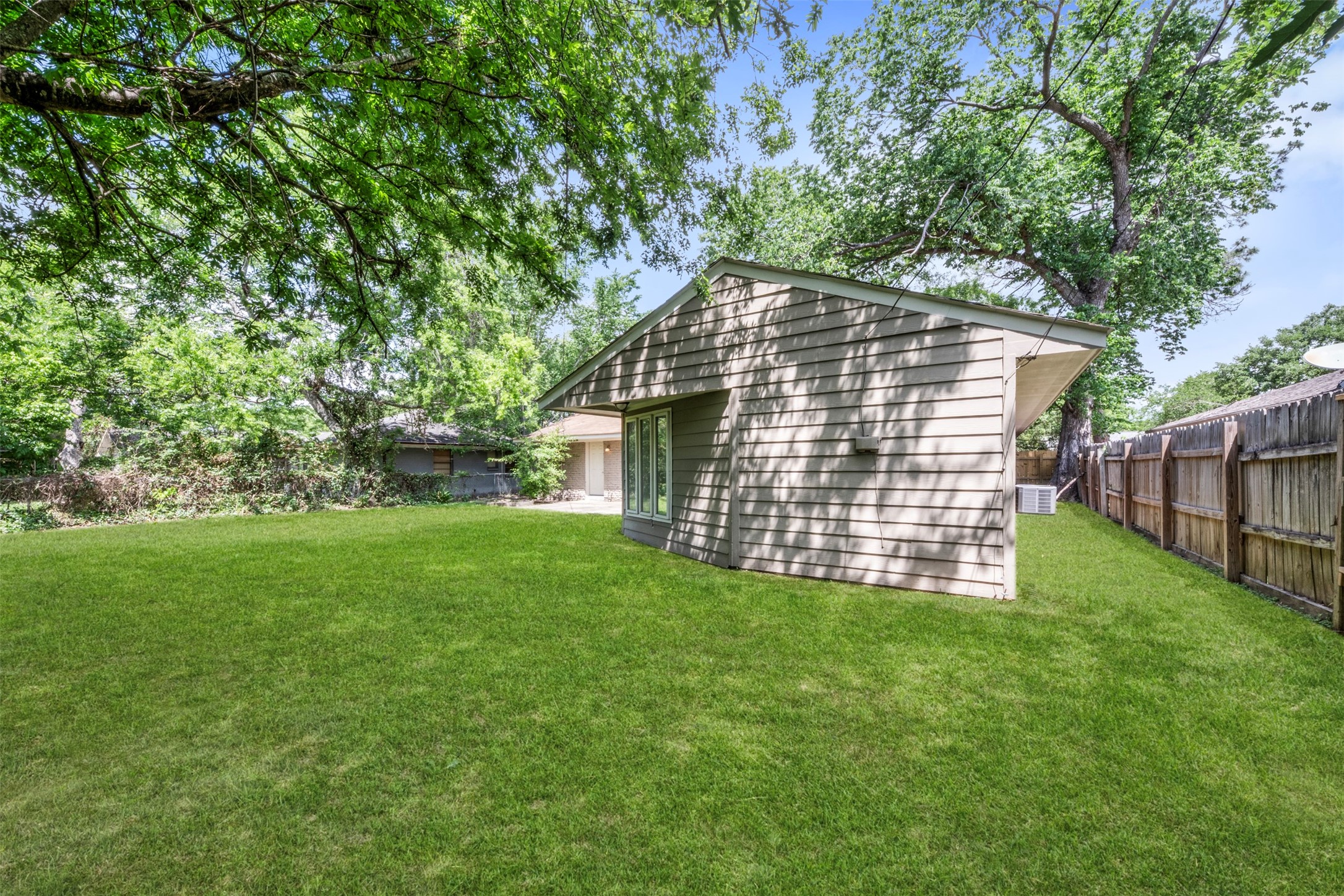 4307 Spellman Road Houston, TX 77035 - Photo 27 of 31 This backyard with mature landscaping is perfect for entertaining family and friends.